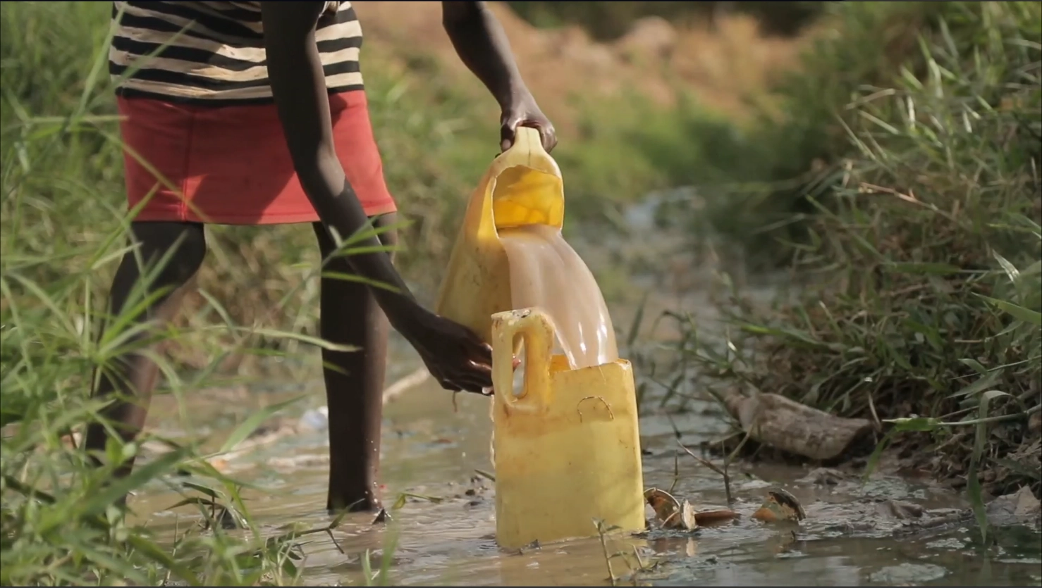 EcoH2O Video Image Overlay - Child pouring dirty water into a plastic yellow makeshift container.